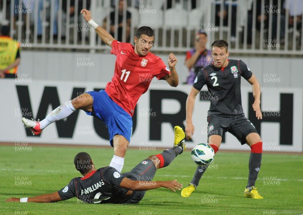 110912 - Serbia v Wales - 2014 World Cup Qualifier -Aleksandar KOLAROV of Serbia is tackled by Ashley Williams of Wales