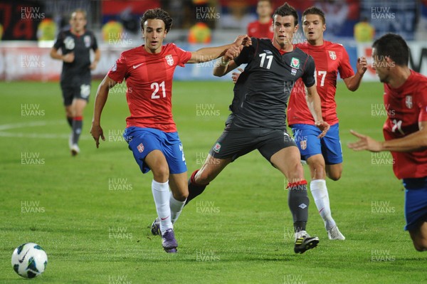 110912 - Serbia v Wales - 2014 World Cup Qualifier -Gareth Bale of Wales competes with Lazar MARKOVIC of Serbia