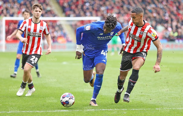 150423 - Sheffield United v Cardiff City - Sky Bet Championship - Sory Kaba of Cardiff is caught by Max Lowe of Sheffield Utd and James McAtee of Sheffield Utd