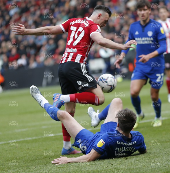230422 - Sheffield United v Cardiff City - Sky Bet Championship - Jordan Hugill of Cardiff is down in the penalty area whilst Jack Robinson of Sheffield Utd takes the ball