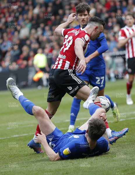 230422 - Sheffield United v Cardiff City - Sky Bet Championship - Jordan Hugill of Cardiff is down in the penalty area whilst Jack Robinson of Sheffield Utd takes the ball