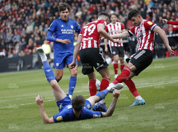 230422 - Sheffield United v Cardiff City - Sky Bet Championship - Jordan Hugill of Cardiff is down in the penalty area whilst Jack Robinson of Sheffield Utd takes the ball and George Baldock of Sheffield Utd clears