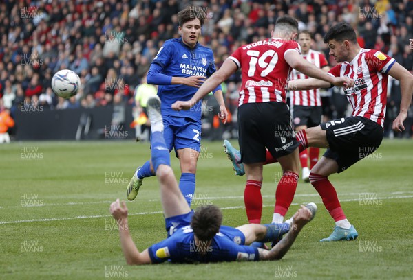 230422 - Sheffield United v Cardiff City - Sky Bet Championship - Jordan Hugill of Cardiff is down in the penalty area whilst Jack Robinson of Sheffield Utd takes the ball and George Baldock of Sheffield Utd clears