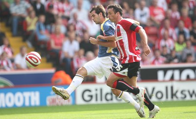 30.08.08...Sheffield United v Cardiff City, Coca Cola Championship -  Cardiff's Joe Ledley beats United's Gary Speed to fire shot at goal 