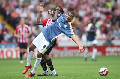 30.08.08...Sheffield United v Cardiff City, Coca Cola Championship -  Cardiff's Jay Bothroyd is held by United's Ugo Ehiogu 