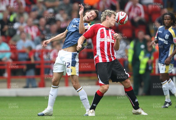 30.08.08...Sheffield United v Cardiff City, Coca Cola Championship -  Cardiff's Roger Johnson and United's Darius Henderson contest the ball 