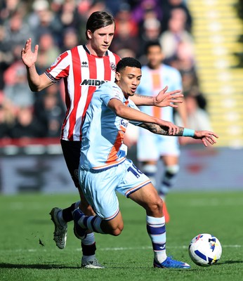 030426 - Sheffield United v Swansea City - Sky Bet Championship - Gustavo Nunes of Swansea and Sydie Peck of Sheffield Utd