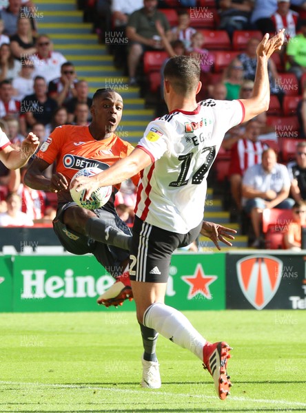 040818 - Sheffield United v Swansea City, Sky Bet Championship - Joel Asoro of Swansea City looks to take a shot at goal as John Egan of Sheffield United closes in to challenge
