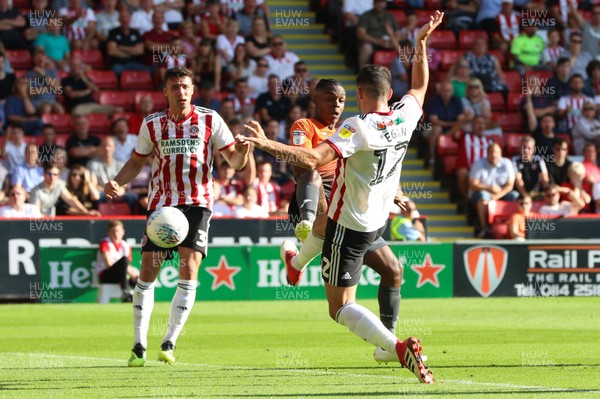 040818 - Sheffield United v Swansea City, Sky Bet Championship - Joel Asoro of Swansea City looks to take a shot at goal as John Egan of Sheffield United closes in to challenge