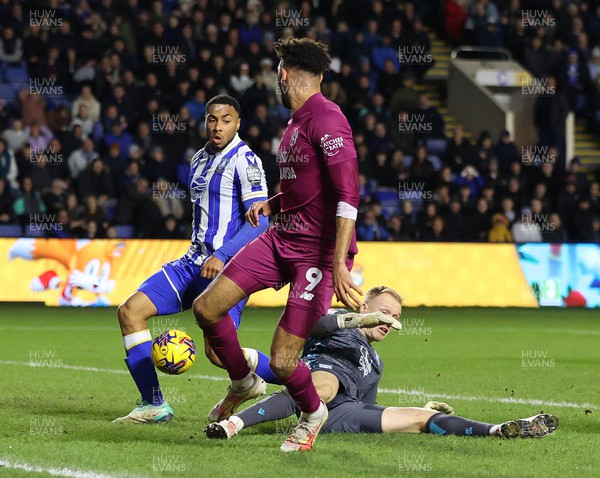 231223 - Sheffield Wednesday v Cardiff City - Sky Bet Championship - Goalkeeper Cameron Dawson of Sheffield Wednesday is floored as Akin Famewo of Sheffield Wednesday [own goal] and Kion Etete of Cardiffnear the goal line