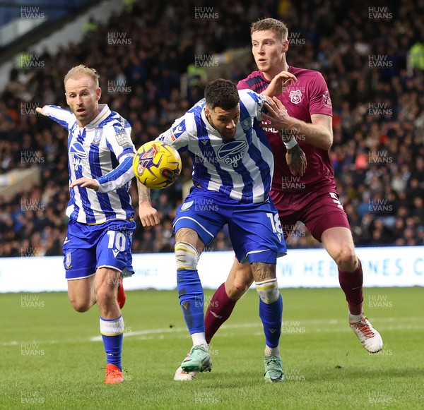  231223 - Sheffield Wednesday v Cardiff City - Sky Bet Championship - Mark McGuinness of Cardiff and Barry Bannan of Sheffield Wednesday and Marvin Johnson of Sheffield Wednesday