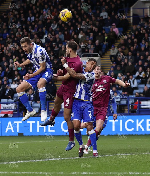 231223 - Sheffield Wednesday v Cardiff City - Sky Bet Championship - Will Vaulks of Sheffield Wednesdaydefends the goal from Demitrios Goutas of Cardiff