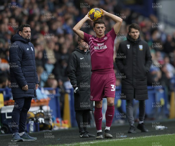 231223 - Sheffield Wednesday v Cardiff City - Sky Bet Championship - Perry Ng of Cardiff throws in watched by both managers