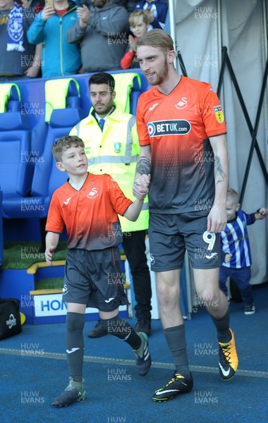 230219 - Sheffield Wednesday v Swansea City - Sky Bet Championship - Oli McBurnie  of Swansea leads out a mascot at the start of the match 