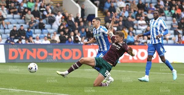 300825 - Sheffield Wednesday v Swansea City - Sky Bet Championship - Cameron Burgess of Swansea and Bailey Cadamarteri of Sheffield Wednesday