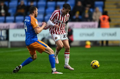 151125 - Shrewsbury Town v Newport County - Sky Bet League 2 - Ben Lloyd of Newport County is tackled by Tom Anderson of Shrewsbury Town