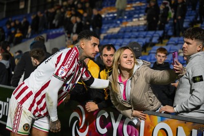 151125 - Shrewsbury Town v Newport County - Sky Bet League 2 - Courtney Baker-Richardson of Newport County has a selfie with a fan at the end of the game