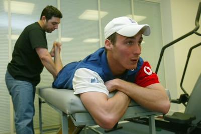 140203 - Glamorgan and England cricketer Simon Jones receiving treatment for his injury from Erjan Mustafa, sports osteopath/physio at Sophia Gardens, Cardiff