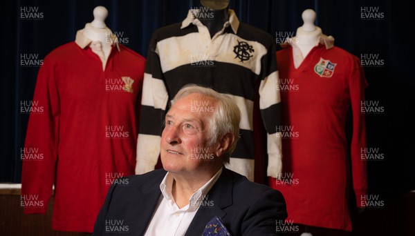 060722 - The Greatest Try Anniversary with Sir Gareth Edwards - Sir Gareth Edwards with three of his match warn shirts, including the Barbarian shirt worn when he scored “The Greatest Try” against New Zealand in 1973 A commissioned painting to mark Sir Gareth Edwards’ 75th birthday, 50th wedding anniversary and 50 years since scoring “The Greatest Try” was unveiled at the same time