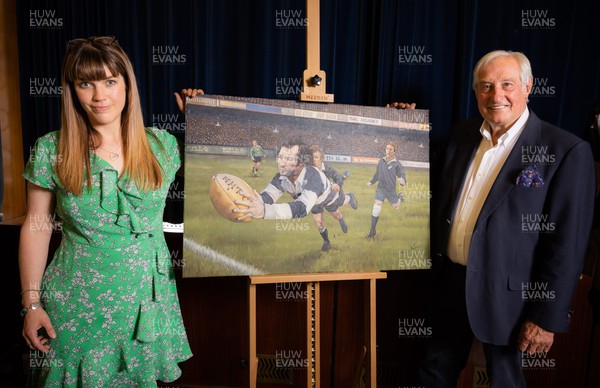 060722 - The Greatest Try Anniversary with Sir Gareth Edwards - Sir Gareth Edwards and artist Elin Sian Blake with a specially commissioned painting to mark Sir Gareth’s 75th birthday, 50th wedding anniversary and 50 years since scoring “The Greatest Try” against New Zealand in 1973