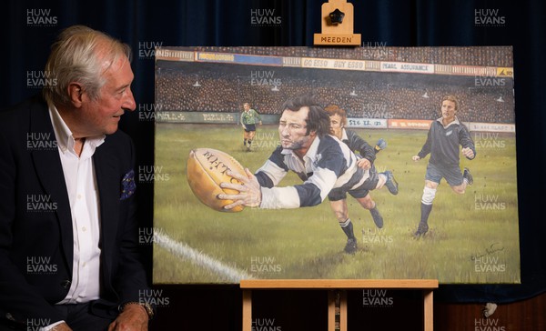 060722 - The Greatest Try Anniversary with Sir Gareth Edwards - Sir Gareth Edwards with a specially commissioned painting to mark his 75th birthday, 50th wedding anniversary and 50 years since scoring “The Greatest Try” against New Zealand in 1973
