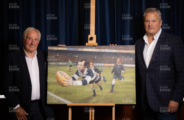 060722 - The Greatest Try Anniversary with Sir Gareth Edwards - Sir Gareth Edwards with Scott Salter and the specially commissioned painting of his 1973 Barbarian try against New Zealand to mark his 75th birthday, 50th wedding anniversary and 50 years since scoring “The Greatest Try” 