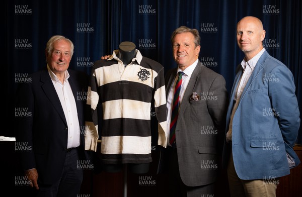 060722 - The Greatest Try Anniversary with Sir Gareth Edwards - Sir Gareth Edwards with auctioneers Richard Madley and Ben Rogers Jones and shirt Sir Gareth wore when he scored the 1973 Barbarian try against New Zealand