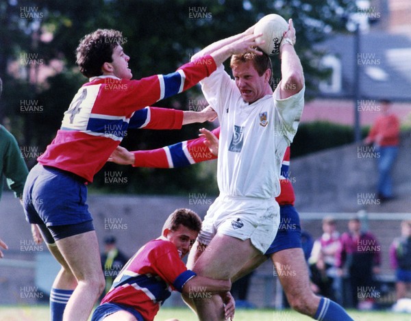 290892 - Swansea v South Wales Police - Snelling Sevens - Swansea's Stuart Davies manages to release the ball as he is caught by Andrew Price (4) and Richard Williams