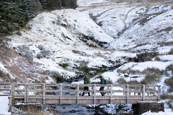 081217 - Weather - Picture shows people walking in the bad weather and snow in the Brecon Beacons near Methyr Tydfil