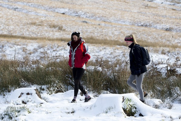 081217 - Weather - Picture shows two walkers making their way through the snow in the Brecon Beacons near Methyr Tydfil