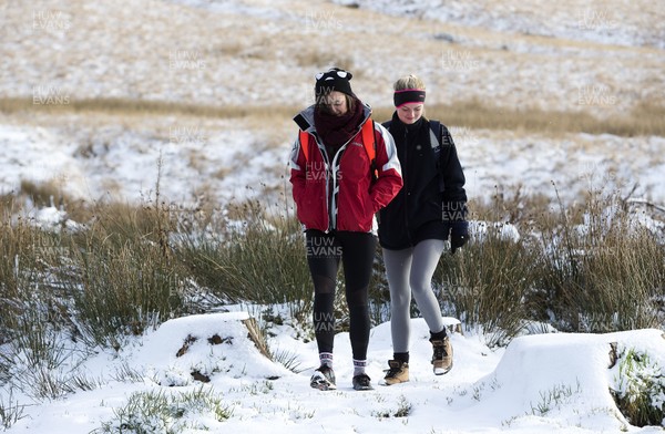081217 - Weather - Picture shows two walkers making their way through the snow in the Brecon Beacons near Methyr Tydfil
