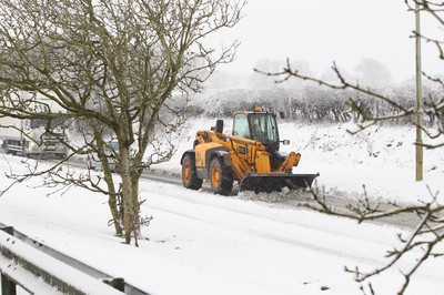 180113 - Snow in South Wales - A snow plough works on the A48 after the M4 was closed at Bridgend