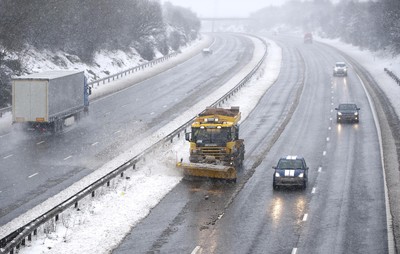 180113 - Cardiff- Snow -   A Snow plough attempts to keep the M4 between Bridgend and Pyle open as snow falls heavily in South Wales 