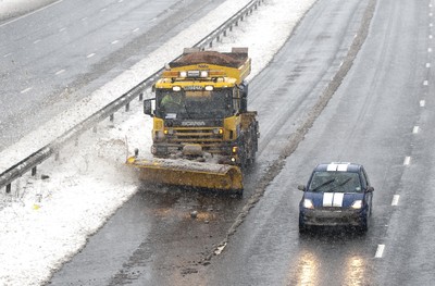 180113 - Cardiff- Snow -   A Snow plough attempts to keep the M4 between Bridgend and Pyle open as snow falls heavily in South Wales 