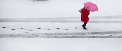 180113 - Snow hits south Wales -A worker makes her way through the snow in Cardiff