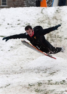 180113 - Snow hits south Wales -Sledgers take to the snow at Cyfarthfa Castle in Merthyr Tydfil