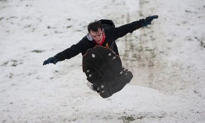 180113 - Snow hits south Wales -Sledgers take to the snow at Cyfarthfa Castle in Merthyr Tydfil