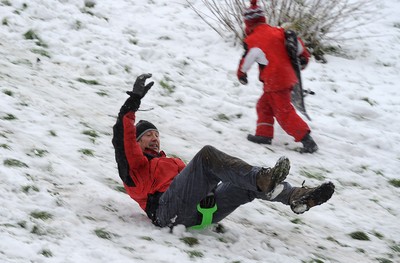 180113 - Heavy Snowfall in South Wales -Children and adults enjoy sledging in the snow in Penarth near Cardiff following heavy snowfall in South Wales