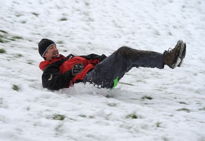 180113 - Heavy Snowfall in South Wales -Children and adults enjoy sledging in the snow in Penarth near Cardiff following heavy snowfall in South Wales