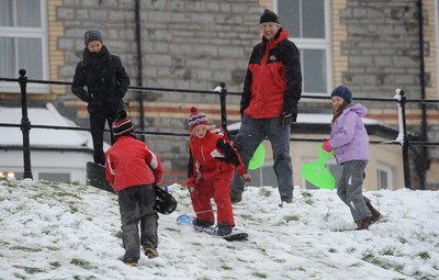 180113 - Heavy Snowfall in South Wales -Children and adults enjoy sledging in the snow in Penarth near Cardiff following heavy snowfall in South Wales