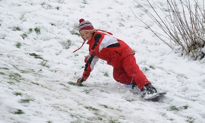 180113 - Heavy Snowfall in South Wales -Children and adults enjoy sledging in the snow in Penarth near Cardiff following heavy snowfall in South Wales