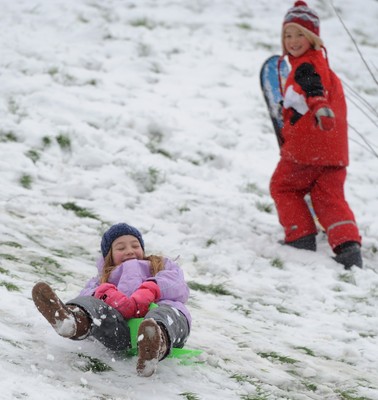 180113 - Heavy Snowfall in South Wales -Children and adults enjoy sledging in the snow in Penarth near Cardiff following heavy snowfall in South Wales