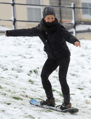 180113 - Heavy Snowfall in South Wales -Children and adults enjoy sledging in the snow in Penarth near Cardiff following heavy snowfall in South Wales