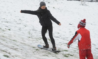 180113 - Heavy Snowfall in South Wales -Children and adults enjoy sledging in the snow in Penarth near Cardiff following heavy snowfall in South Wales