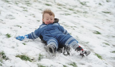 180113 - Heavy Snowfall in South Wales -Children and adults enjoy sledging in the snow in Penarth near Cardiff following heavy snowfall in South Wales