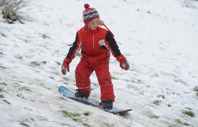 180113 - Heavy Snowfall in South Wales -Children and adults enjoy sledging in the snow in Penarth near Cardiff following heavy snowfall in South Wales