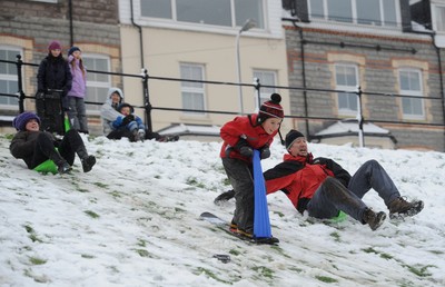 180113 - Heavy Snowfall in South Wales -Children and adults enjoy sledging in the snow in Penarth near Cardiff following heavy snowfall in South Wales