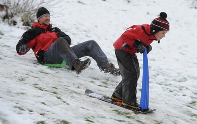 180113 - Heavy Snowfall in South Wales -Children and adults enjoy sledging in the snow in Penarth near Cardiff following heavy snowfall in South Wales