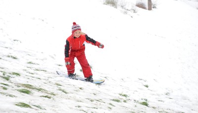 180113 - Heavy Snowfall in South Wales -Children and adults enjoy sledging in the snow in Penarth near Cardiff following heavy snowfall in South Wales