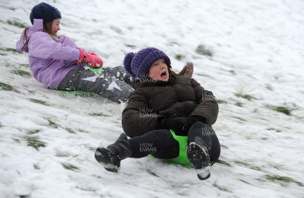 180113 - Heavy Snowfall in South Wales -Children and adults enjoy sledging in the snow in Penarth near Cardiff following heavy snowfall in South Wales